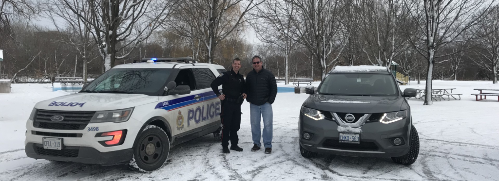 police and resident standing between their cars parked side by side in Brantwood Park