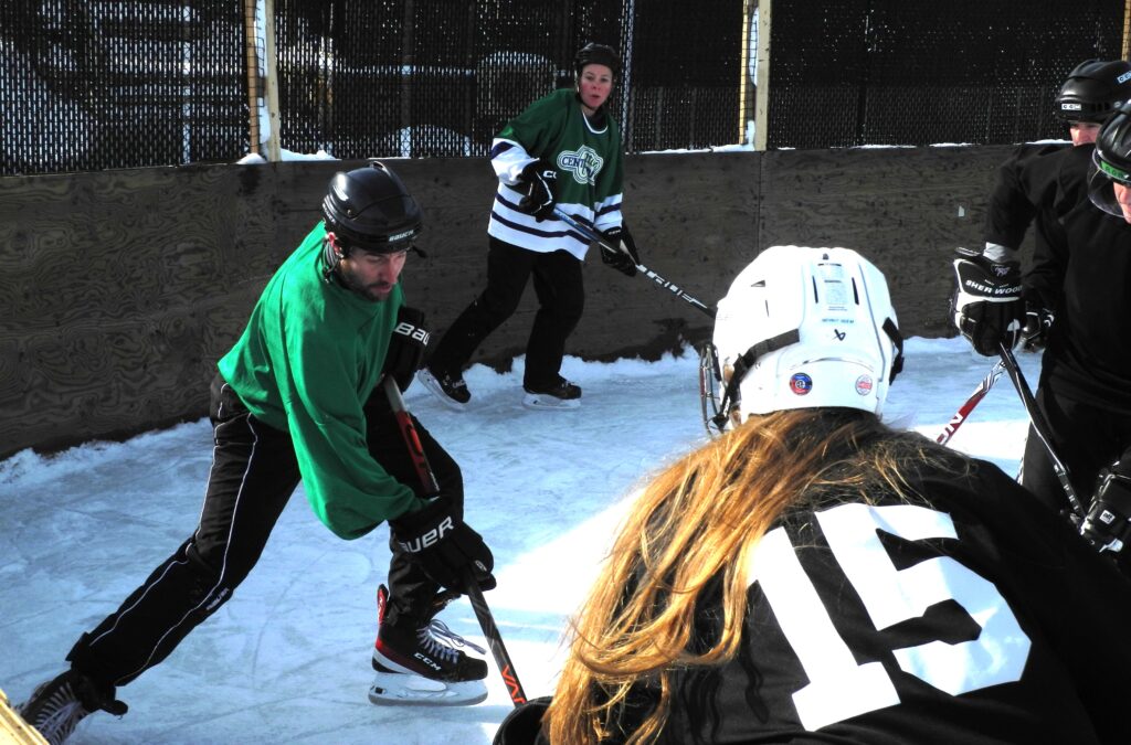 opposing players facing off for puck